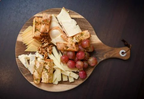 Cheese Platter with Grapes, Walnuts, and Toasted Bread Stock Photos