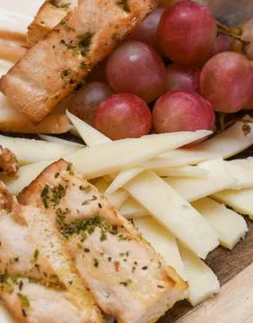 Cheese Platter with Grapes, Walnuts, and Toasted Bread Stock Photos