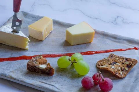 Cheese platter witch assorted cheese and grapes Stock Photos