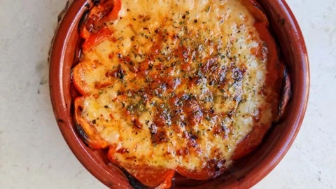 Cheese provolone with olive oil, pepper, tomatos boiling in bowl Video stock 324255109