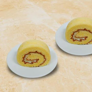 Cheese rolled sponge cake on a white plate Stock Photos