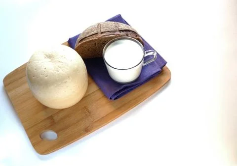 The cheese is a round head cut with bread, baguette, sesame bun Stock Photos