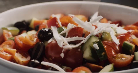 Cheese rubbed on a fresh vegetable salad, healthy food. Stock Footage 149116143