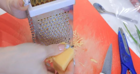 Cheese is rubbed in the kitchen Video stock 145956448