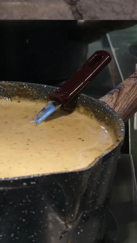 Cheese sauce pot cooked in pan. Slow motion video processed cheese releases Stock Footage 310488024