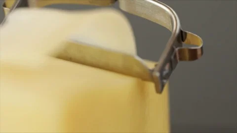 Cheese Scraper makes wafer-thin Cheese Strips Slowmotion Closeup Stock Footage 99197751