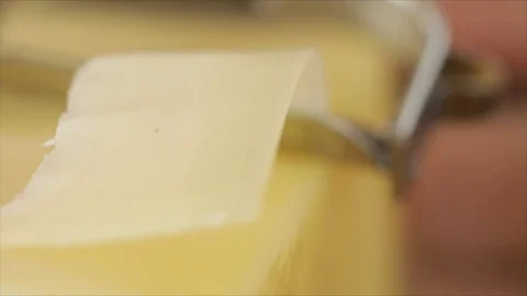 Cheese Scraper makes wafer-thin Cheese Strips Slowmotion Closeup Stock Footage 99197793