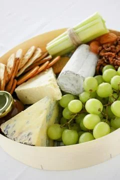 Cheese selection with fruit and nuts Stock Photos