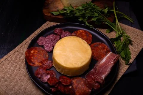 Cheese with serrano ham, olives on a table for a party with friends or as an  Stock Photos