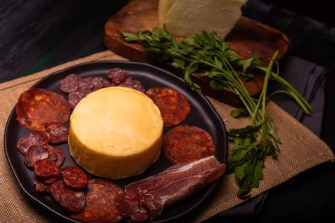 Cheese with serrano ham, olives on a table for a party with friends or as an  Stock Photos