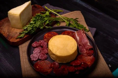 Cheese with serrano ham, olives on a table for a party with friends or as an  Stock Photos