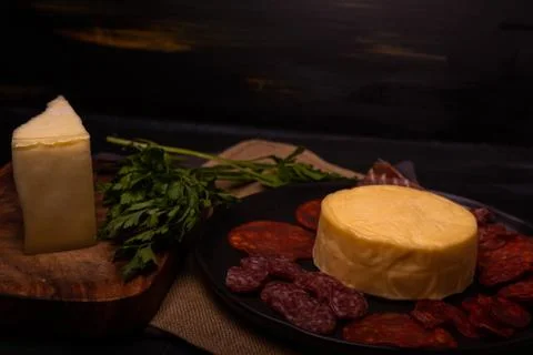 Cheese with serrano ham, olives on a table for a party with friends or as an  Stock Photos