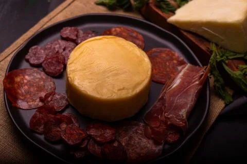 Cheese with serrano ham, olives on a table for a party with friends or as an  Stock Photos