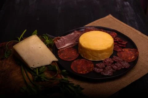 Cheese with serrano ham, olives on a table for a party with friends or as an  Stock Photos