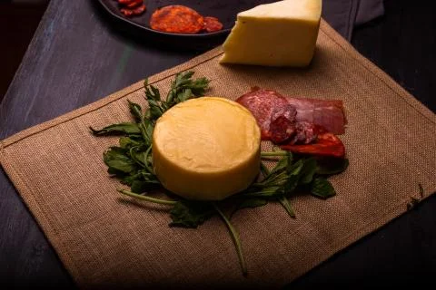 Cheese with serrano ham, olives on a table for a party with friends or as an  Stock Photos