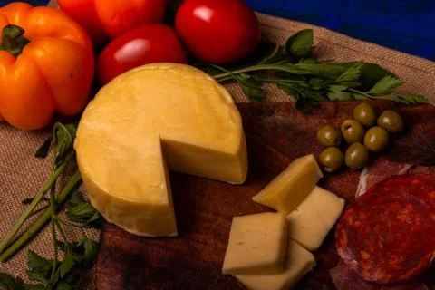 Cheese with serrano ham, olives on a table for a party with friends or as an  Stock Photos