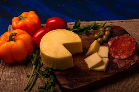 Cheese with serrano ham, olives on a table for a party with friends or as an  Stock Photos