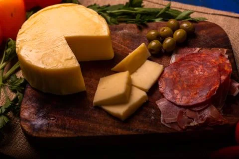 Cheese with serrano ham, olives on a table for a party with friends or as an  Stock Photos