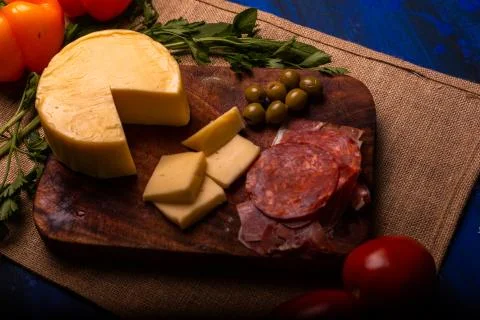 Cheese with serrano ham, olives on a table for a party with friends or as an  Stock Photos