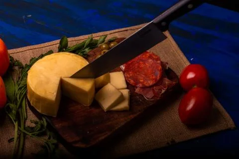 Cheese with serrano ham, olives on a table for a party with friends or as an  Stock Photos