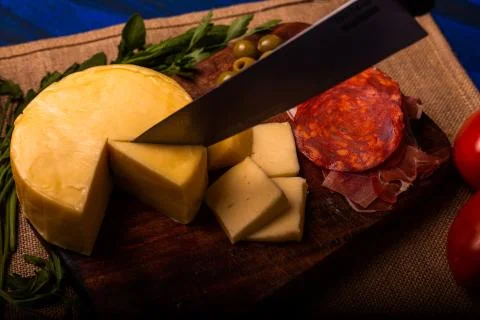 Cheese with serrano ham, olives on a table for a party with friends or as an  Stock Photos