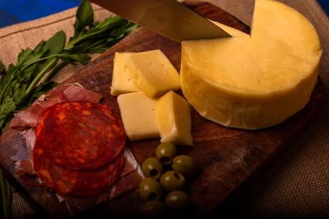 Cheese with serrano ham, olives on a table for a party with friends or as an  Stock Photos
