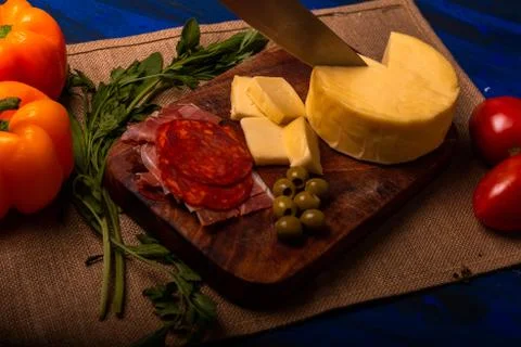 Cheese with serrano ham, olives on a table for a party with friends or as an  Stock Photos