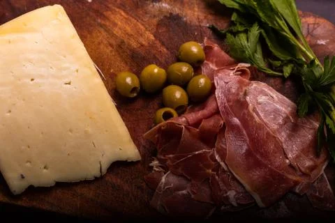 Cheese with serrano ham, olives on a table for a party with friends or as an  Stock Photos