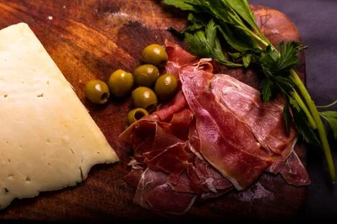Cheese with serrano ham, olives on a table for a party with friends or as an  Stock Photos
