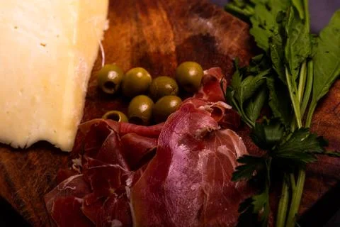 Cheese with serrano ham, olives on a table for a party with friends or as an  Stock Photos