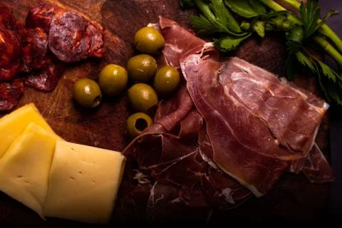 Cheese with serrano ham, olives on a table for a party with friends or as an  Stock Photos