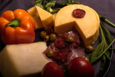 Cheese with serrano ham, olives on a table for a party with friends or as an  Stock Photos