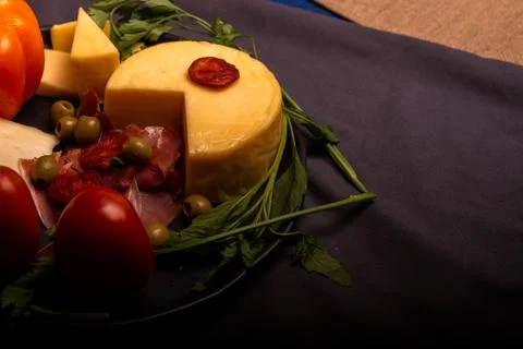 Cheese with serrano ham, olives on a table for a party with friends or as an  Stock Photos