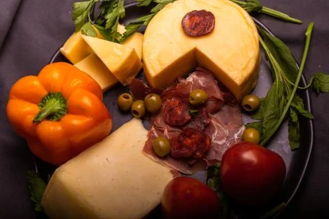 Cheese with serrano ham, olives on a table for a party with friends or as an  Foto stock
