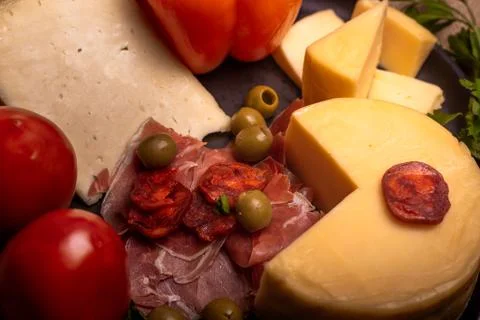 Cheese with serrano ham, olives on a table for a party with friends or as an  Stock Photos