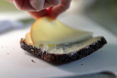 Cheese Slice on Black Bread: A Savory Delight Stock Photos