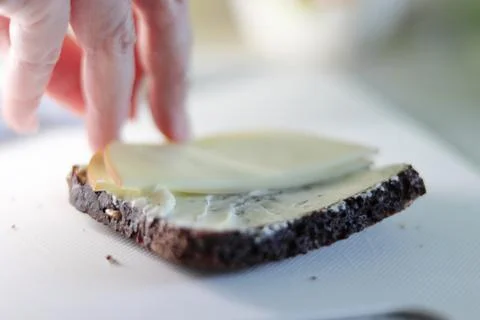 Cheese Slice on Black Bread: A Savory Delight Stock Photos