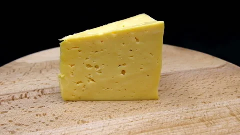 Cheese slowly rotates in front of the camera Stock Footage 104919038