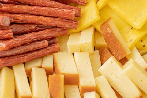 Cheese snacks in one container. Sliced cheese in different shapes Stock Photos