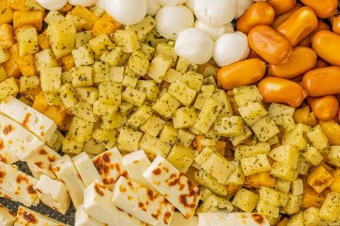Cheese snacks in one container. Sliced cheese in different shapes. Stock Photos