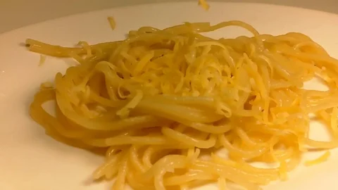 Cheese is strewed on spaghetti Stock Footage 82819127