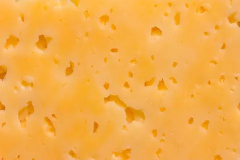 Cheese surface with openings close-up Stock Photos