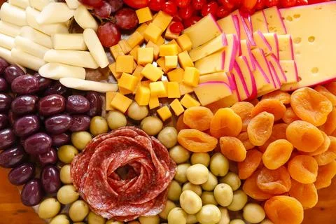 Cheese on table with snacks - party buffet with various savory foods Stock Photos