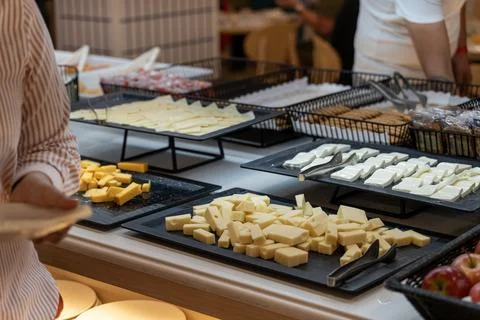 Cheese Tasting Buffet with Assorted Cheese Pieces and Crackers 스톡 사진