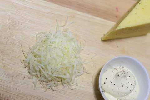Cheese triangular slice a serving of grated cheese sauce sauce seasoned mayon Stock Photos