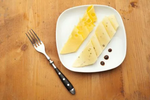 Cheese on white plate Stock Photos