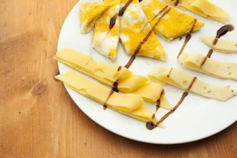 Cheese on white plate Stock Photos