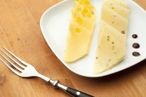 Cheese on white plate Stock Photos
