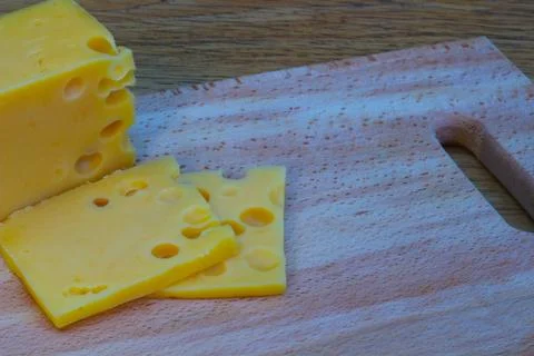 Cheese on a wooden table Stock Photos