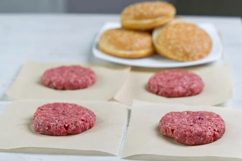 Cheeseburger and beefburger ingredients. bun and raw burger cutlets. Burger bbq Stock Photos